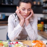 Depressed and sad woman in kitchen Depressed and sad woman in kitchen